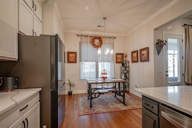 kitchen with crown molding, light stone countertops, decorative light fixtures, white cabinetry, and dark hardwood / wood-style flooring