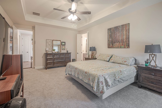 bedroom featuring crown molding, ceiling fan, light colored carpet, and a raised ceiling