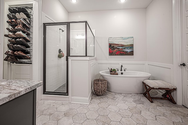 bathroom featuring vanity, shower with separate bathtub, and tile patterned floors