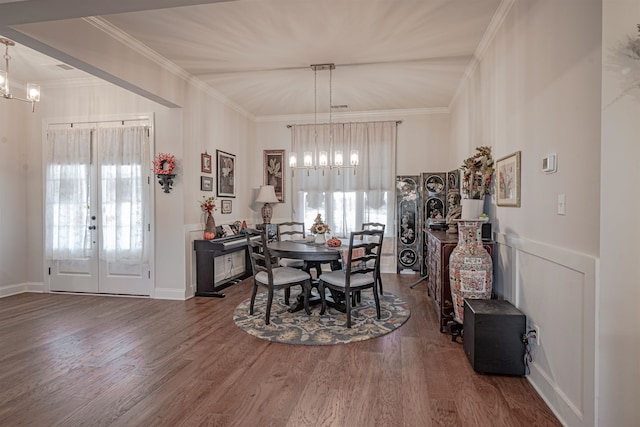 dining area featuring dark wood-type flooring, french doors, and ornamental molding