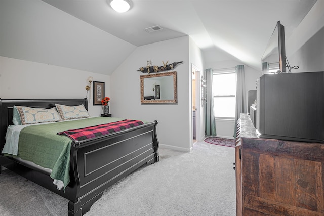 bedroom featuring vaulted ceiling and light colored carpet