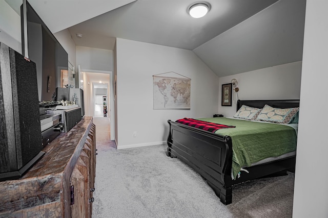 carpeted bedroom featuring vaulted ceiling