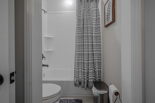 bathroom with shower / bath combo with shower curtain and toilet