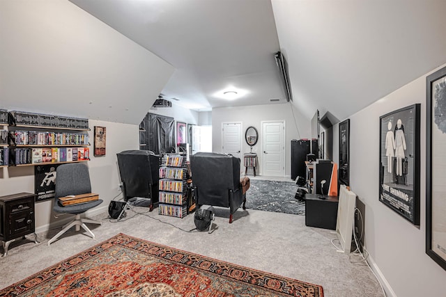 carpeted home office featuring vaulted ceiling