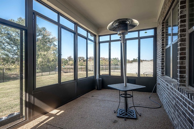 sunroom / solarium with plenty of natural light and ceiling fan