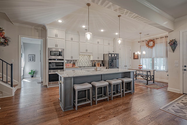 kitchen with a spacious island, stainless steel appliances, dark hardwood / wood-style flooring, and white cabinets