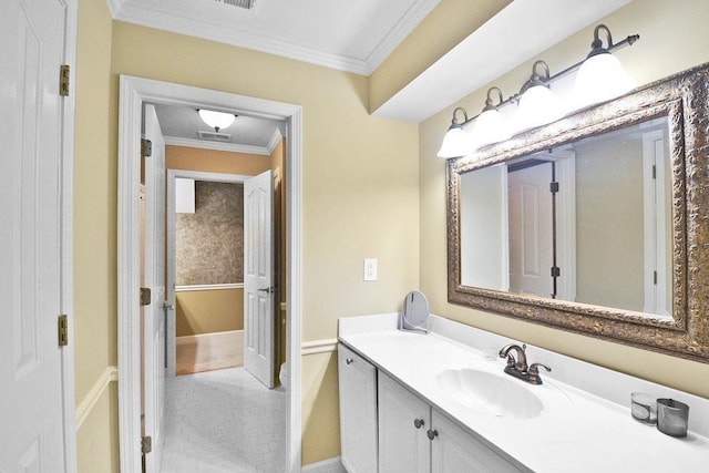 bathroom featuring visible vents, vanity, ornamental molding, and baseboards