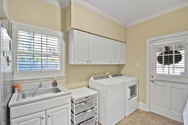 laundry area featuring light tile patterned floors, crown molding, a sink, washer and dryer, and cabinet space