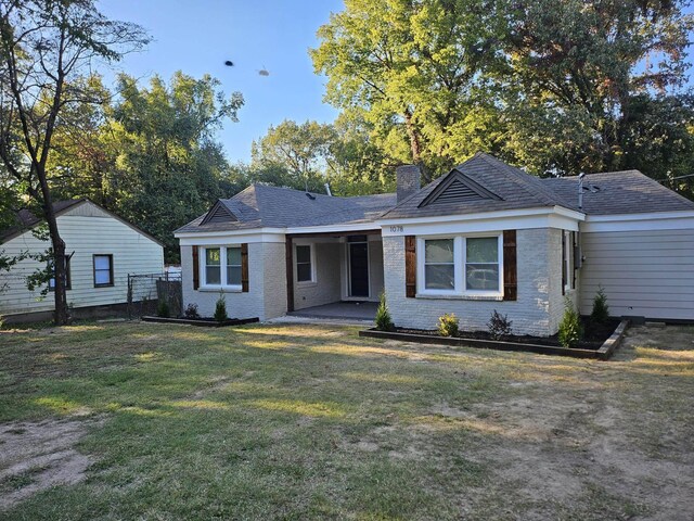 1078 N Ball Rd, Memphis, TN 38106 - ranch-style home with a chimney, a patio area, brick siding, fence, and a front lawn