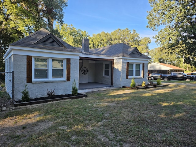 1078 N Ball Rd, Memphis, TN 38106 - view of front of property featuring brick siding, a chimney, and a front lawn