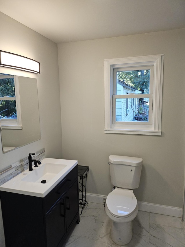 1078 N Ball Rd, Memphis, TN 38106 - half bathroom featuring a healthy amount of sunlight, toilet, and marble finish floor