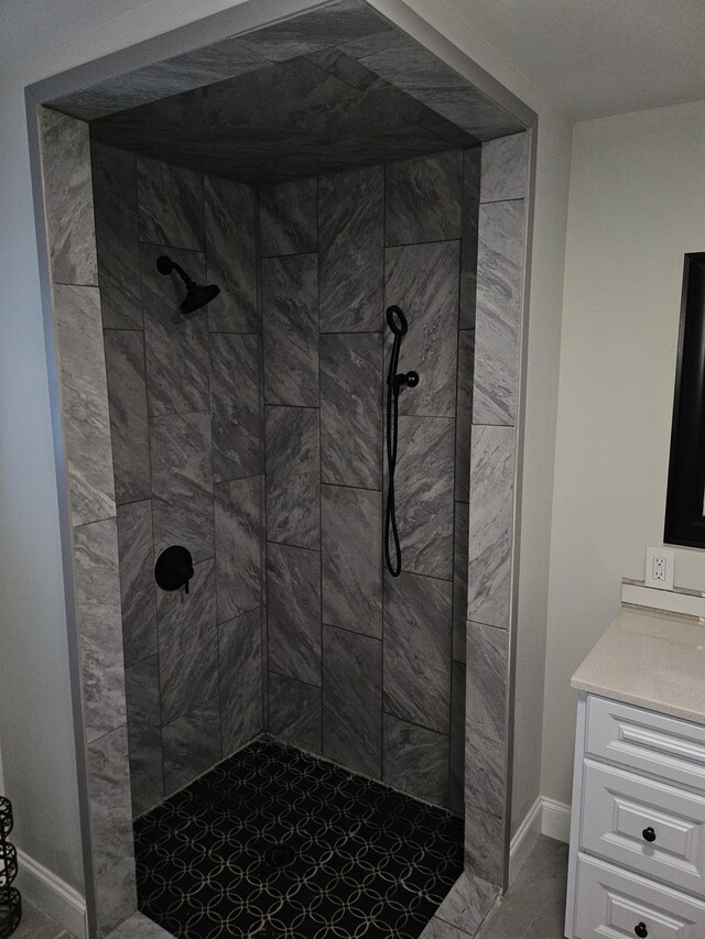 1078 N Ball Rd, Memphis, TN 38106 - bathroom featuring baseboards, vanity, and tiled shower