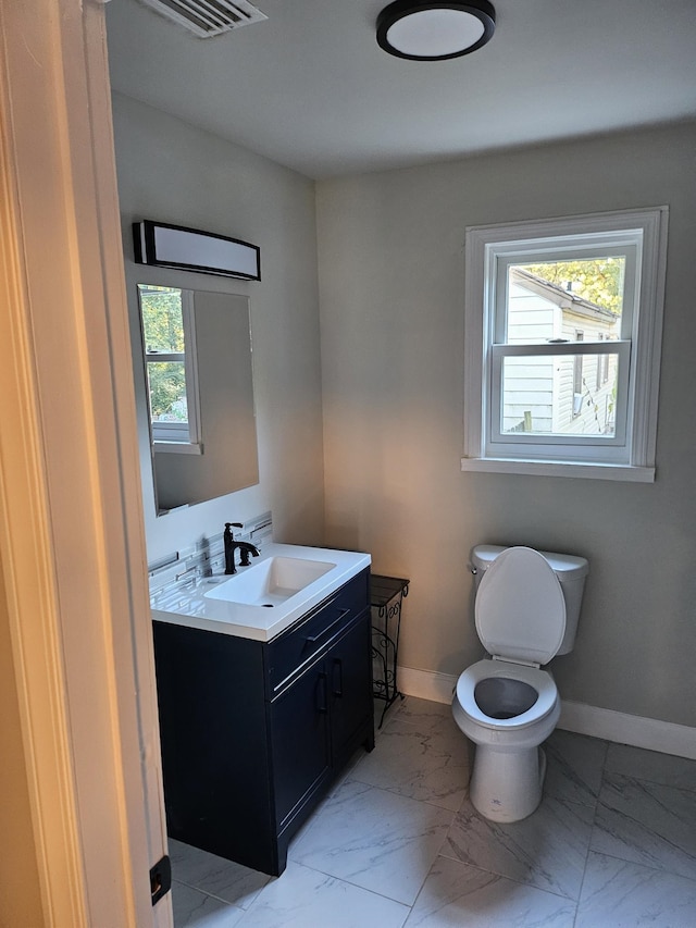 bathroom featuring vanity and toilet