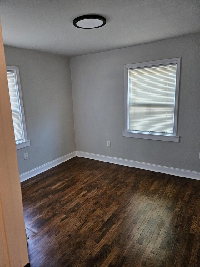 1078 N Ball Rd, Memphis, TN 38106 - unfurnished room with baseboards and dark wood-type flooring