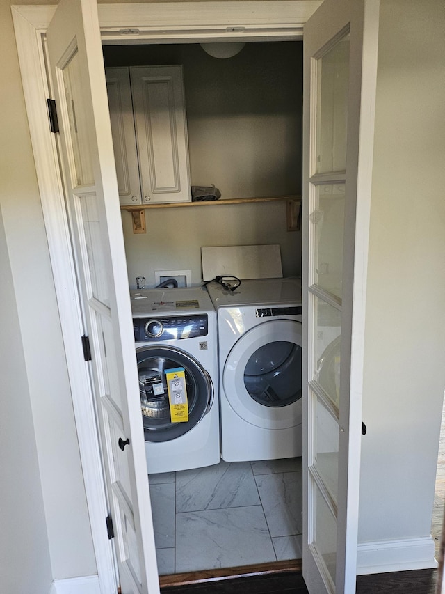 1078 N Ball Rd, Memphis, TN 38106 - laundry area featuring washing machine and clothes dryer, marble finish floor, and cabinet space