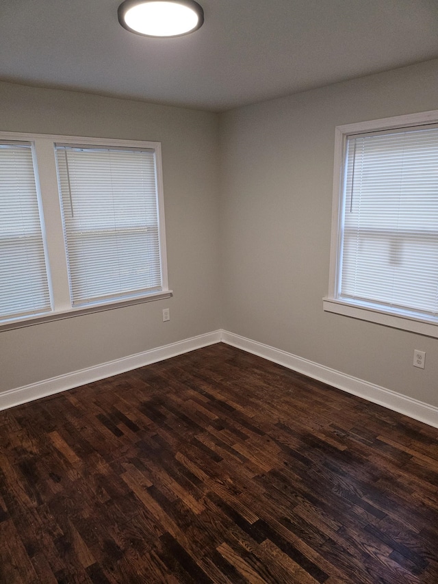 spare room with dark wood-type flooring