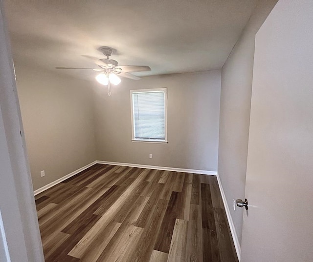 spare room with ceiling fan and dark hardwood / wood-style flooring