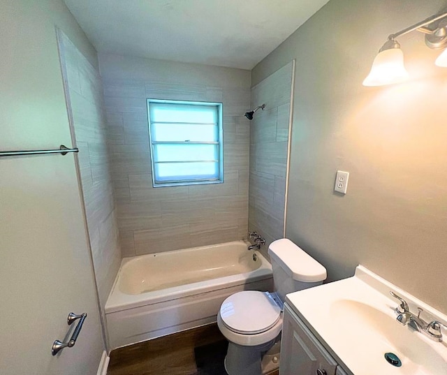 full bathroom with vanity, tiled shower / bath combo, hardwood / wood-style flooring, and toilet