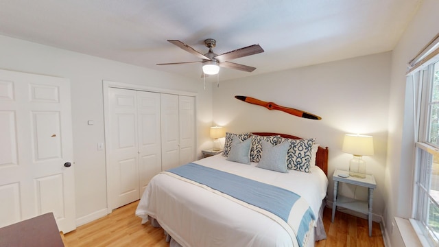 bedroom featuring light hardwood / wood-style flooring, a closet, and ceiling fan