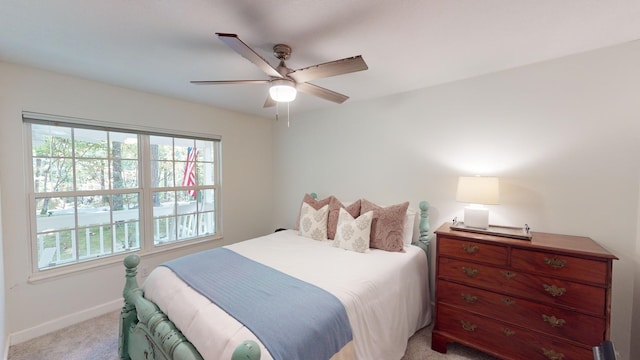 bedroom featuring light carpet and ceiling fan