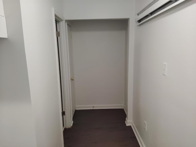 corridor with dark hardwood / wood-style flooring