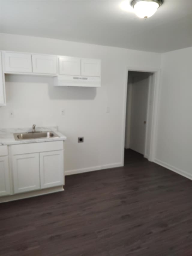 kitchen featuring dark hardwood / wood-style floors, white cabinetry, and sink