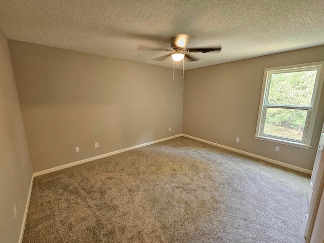 spare room featuring ceiling fan, carpet, and a textured ceiling