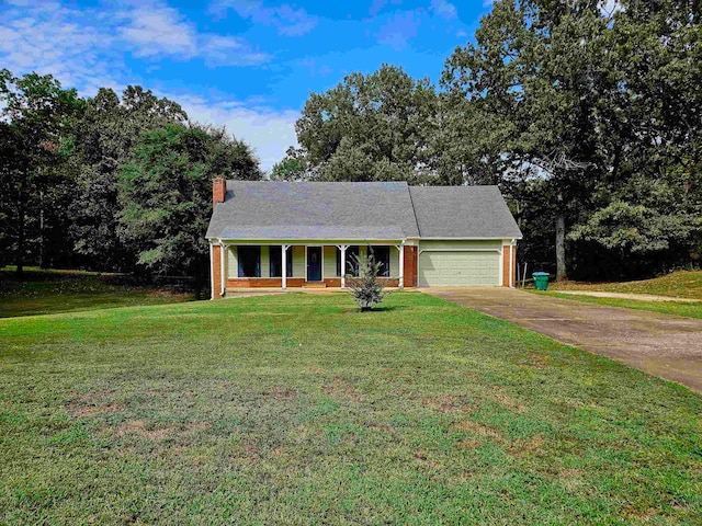 view of front of home featuring a front yard, a porch, and a garage