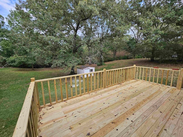 deck featuring a shed and a lawn