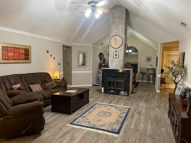 living room featuring ornamental molding, ceiling fan, hardwood / wood-style floors, and vaulted ceiling