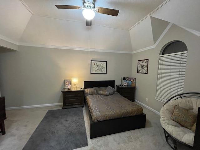 bedroom featuring lofted ceiling, ornamental molding, light colored carpet, and ceiling fan