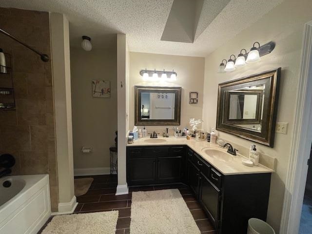 bathroom with vanity and a textured ceiling