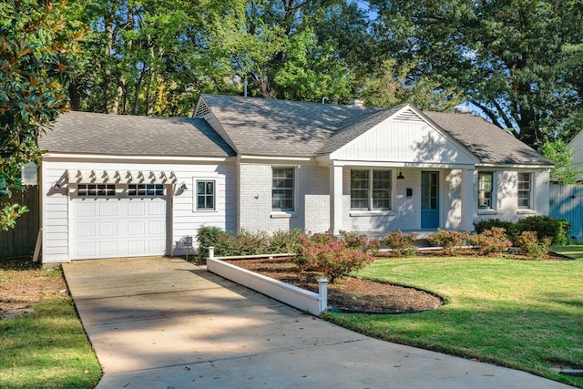 view of front of property featuring a garage and a front lawn