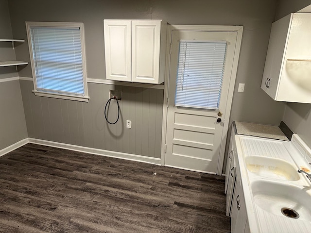 clothes washing area featuring sink, hookup for a washing machine, and dark hardwood / wood-style floors