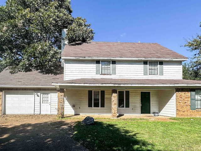 view of front facade with a front yard and a garage