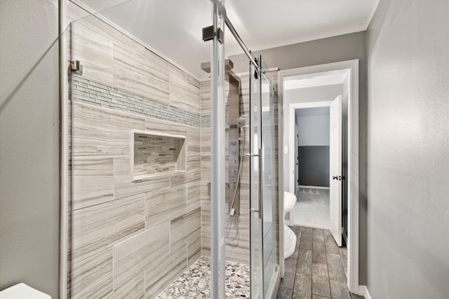 bathroom featuring a shower with door and hardwood / wood-style flooring