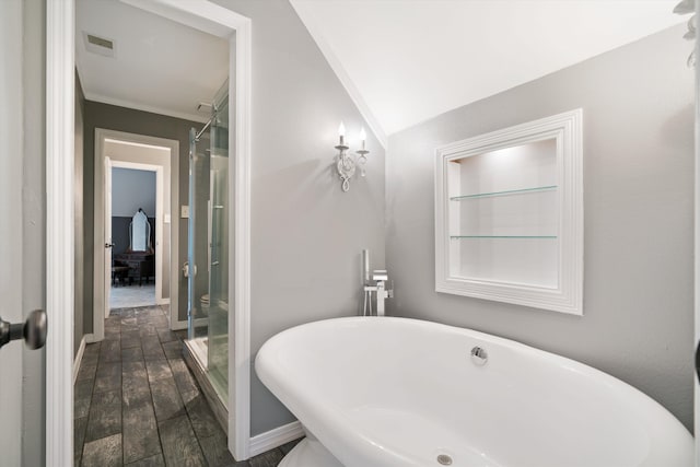 bathroom featuring crown molding, wood-type flooring, vaulted ceiling, and separate shower and tub