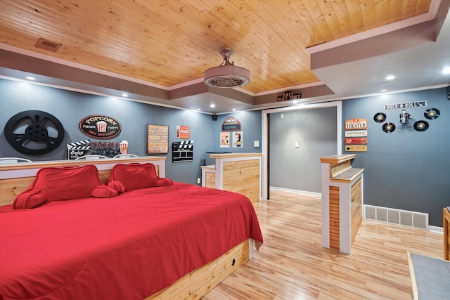 bedroom featuring light hardwood / wood-style floors, crown molding, and wooden ceiling