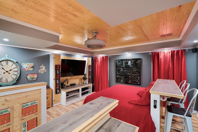 home theater featuring light hardwood / wood-style flooring, ornamental molding, and wood ceiling