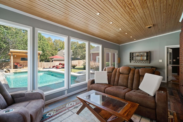 living room featuring wood ceiling, crown molding, plenty of natural light, and hardwood / wood-style floors