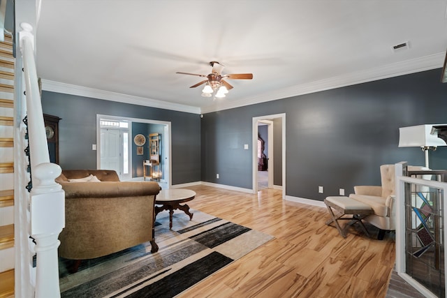 living room featuring ornamental molding, hardwood / wood-style floors, and ceiling fan