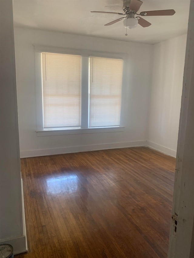 spare room featuring dark hardwood / wood-style floors and ceiling fan