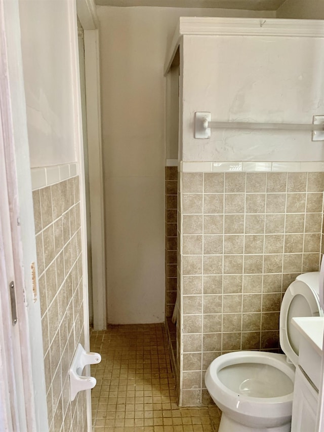 1616 Kendale Ave, Memphis, TN 38106 - bathroom with toilet, tile walls, tile patterned floors, vanity, and wainscoting