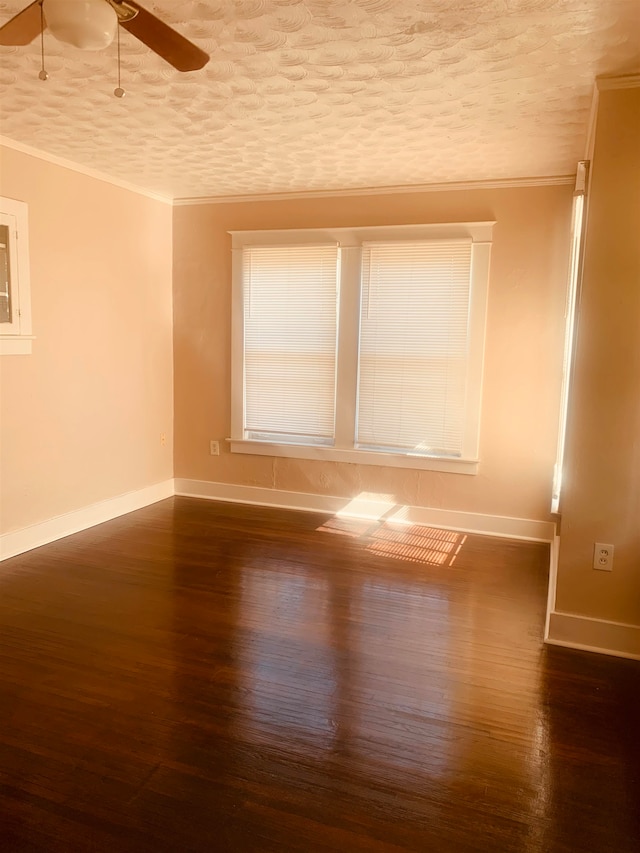 unfurnished room with ornamental molding, a textured ceiling, dark hardwood / wood-style floors, and ceiling fan