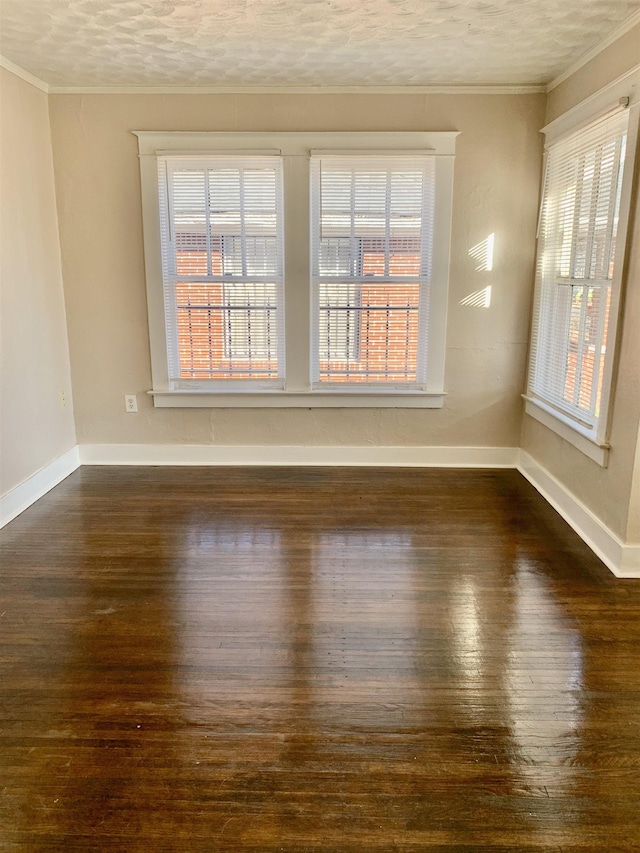 1616 Kendale Ave, Memphis, TN 38106 - empty room featuring dark wood-style floors, ornamental molding, and plenty of natural light