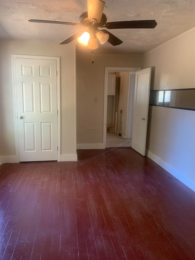 unfurnished bedroom with dark hardwood / wood-style floors and ceiling fan