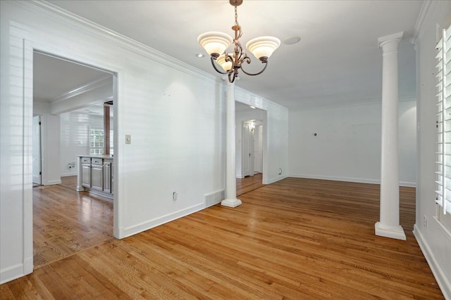 unfurnished dining area featuring wood-type flooring, an inviting chandelier, and ornamental molding