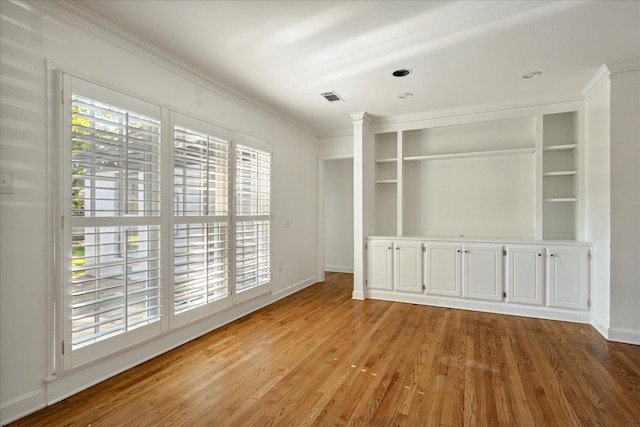 interior space featuring ornamental molding and light wood-type flooring