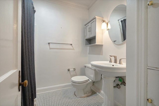 bathroom featuring tile patterned floors, crown molding, and toilet