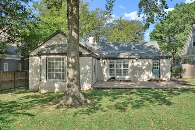 rear view of property with a patio area and a yard